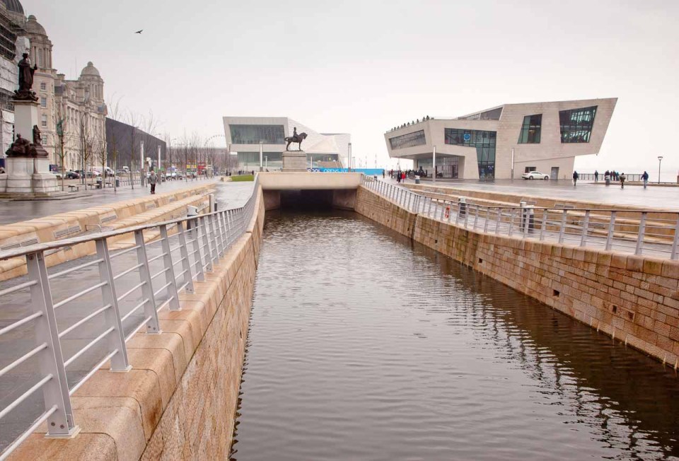 Looking south over the Pier Head Gardens, the Port of Liverpool Building is on the left. The newly completed Museum of Liverpool is straight ahead and the new Mersey Ferries Terminal on the right. The link canal in the centre passes the museum by tunnel into Canning Dock.